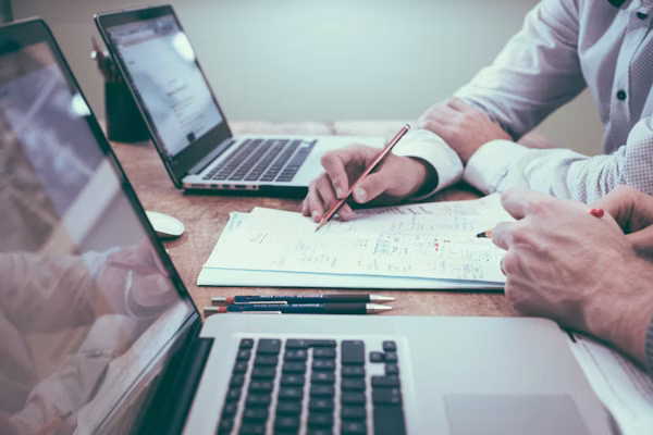 Business directors reviewing unpaid commercial invoices and financial statements